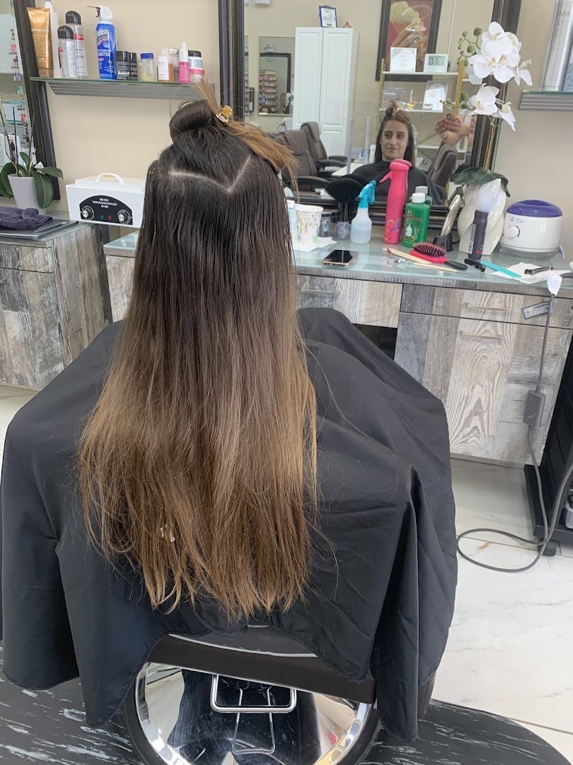 Hair styling station with salon chairs and mirrors.